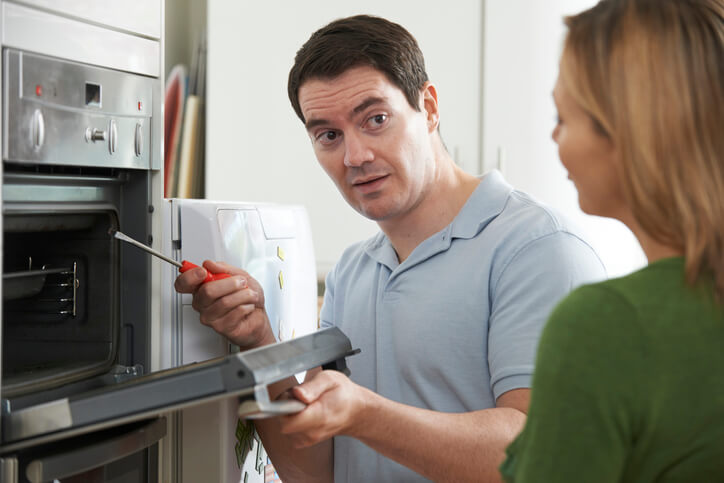 Electrician Fixing Oven